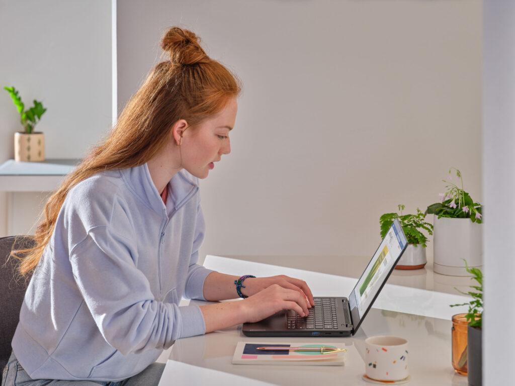 K12 student typing into a Word document on an HP Stream Pro G5