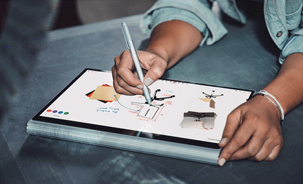 Image of a hand holding a pen and drawing on a tablet that displays Microsoft Whiteboard Preview.