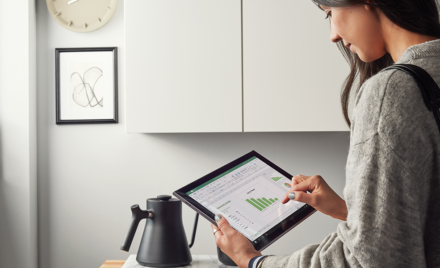 Image for: Image of a woman looking at an Excel graph on her tablet.