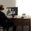 Teams call with headphones at a home desk on a Lenovo ThinkPad X1 Carbon.