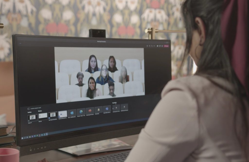 Person looking at meeting occurring on monitor