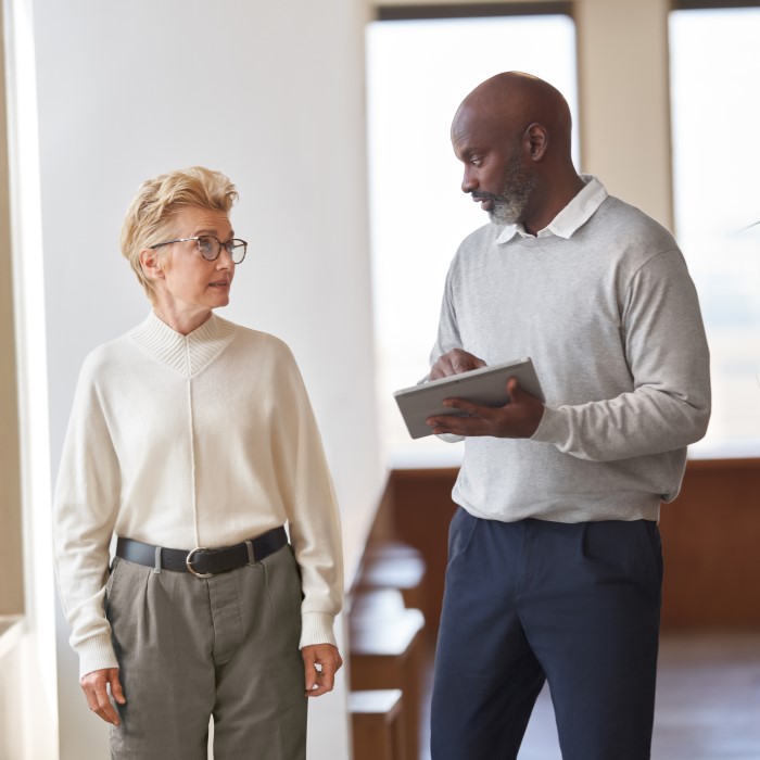 Employees talking in a hallway.