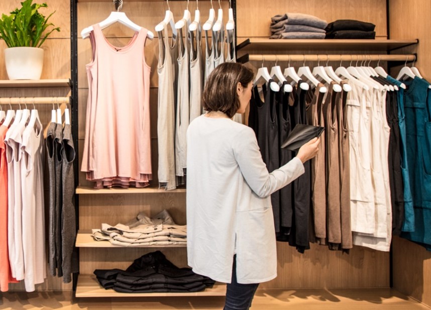 A small business owner in a retail store using Microsoft 365 on a tablet.