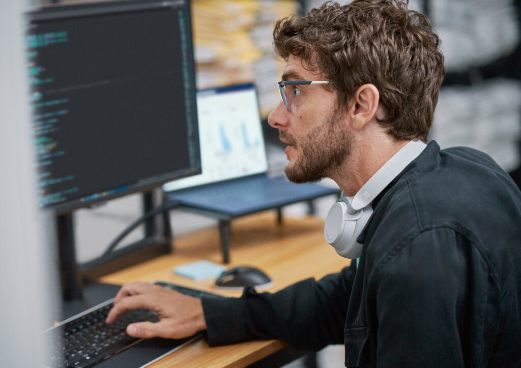 a man standing in front of a computer