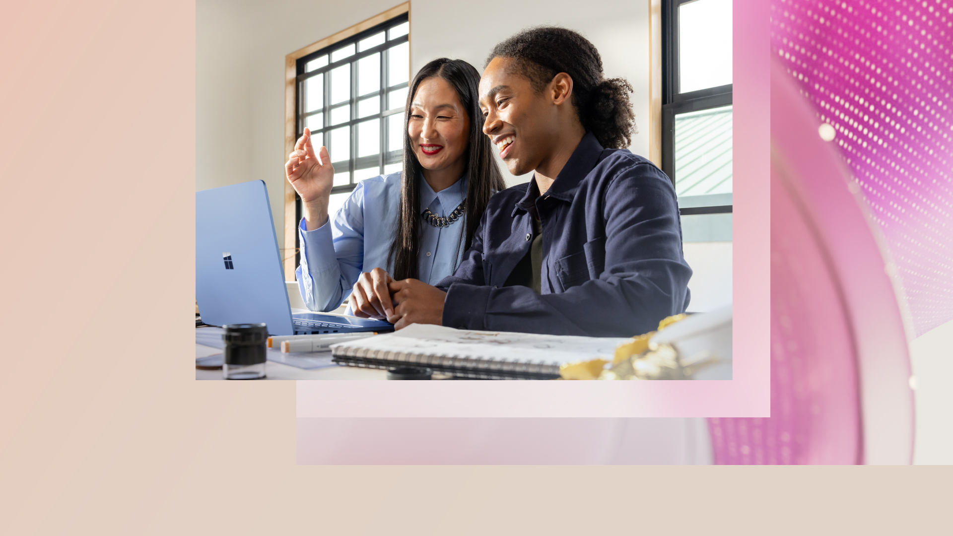 Two business people reviewing work on a laptop