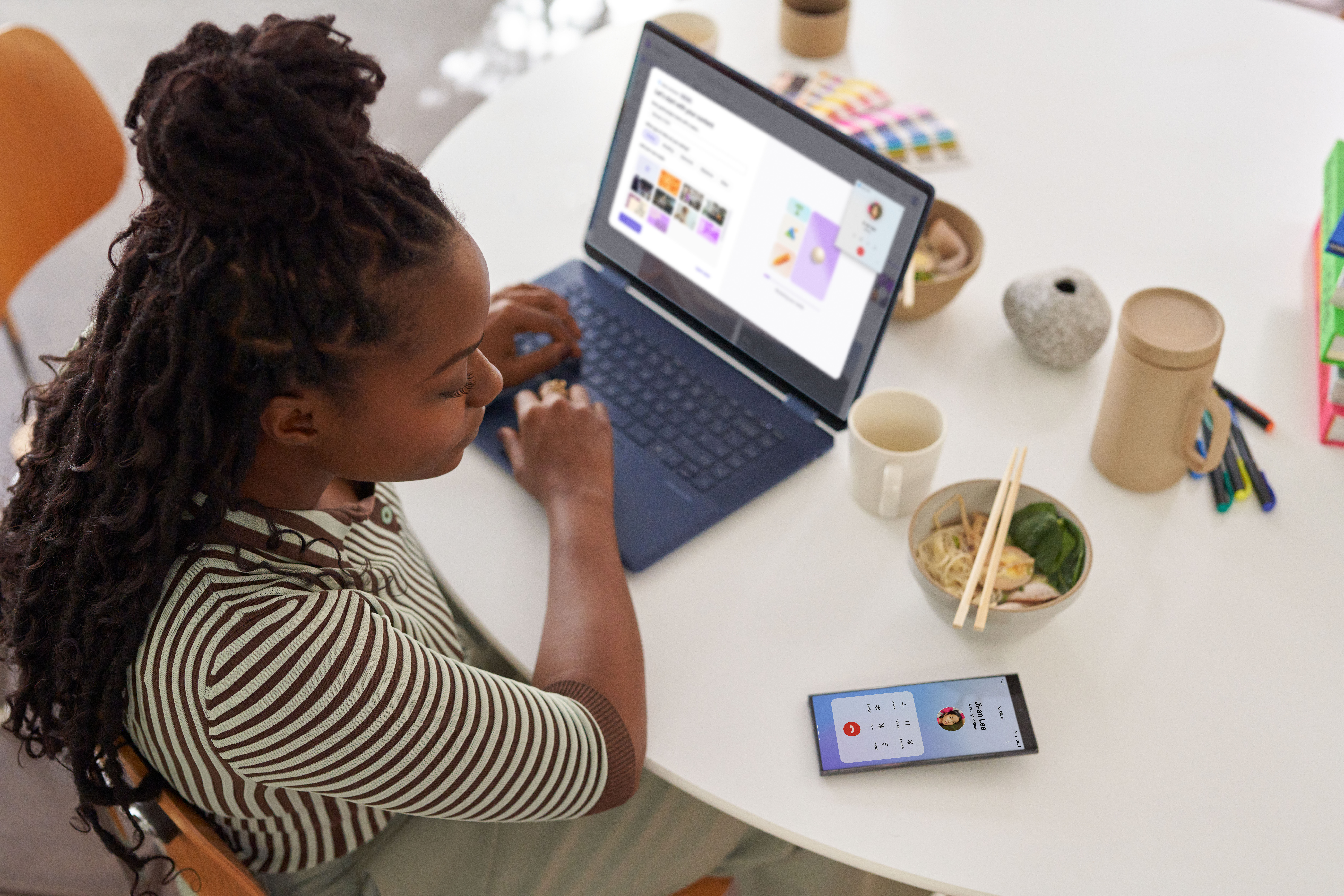 A woman sitting at a table using a laptop