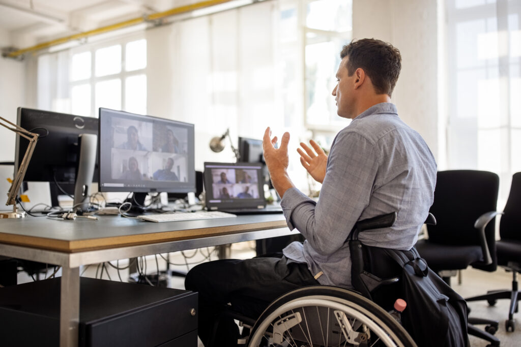 A man in a wheelchair talking to a group of people