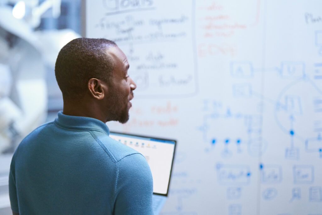 A man looking at a whiteboard