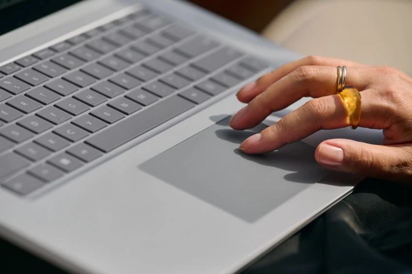 Decorative, close up of a hand on a Laptop 5 in Platinum using track pad.