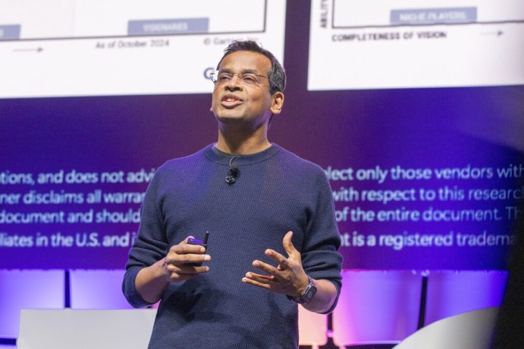 A man standing in front of a screen