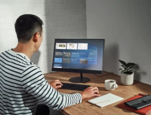 a man standing in front of a computer