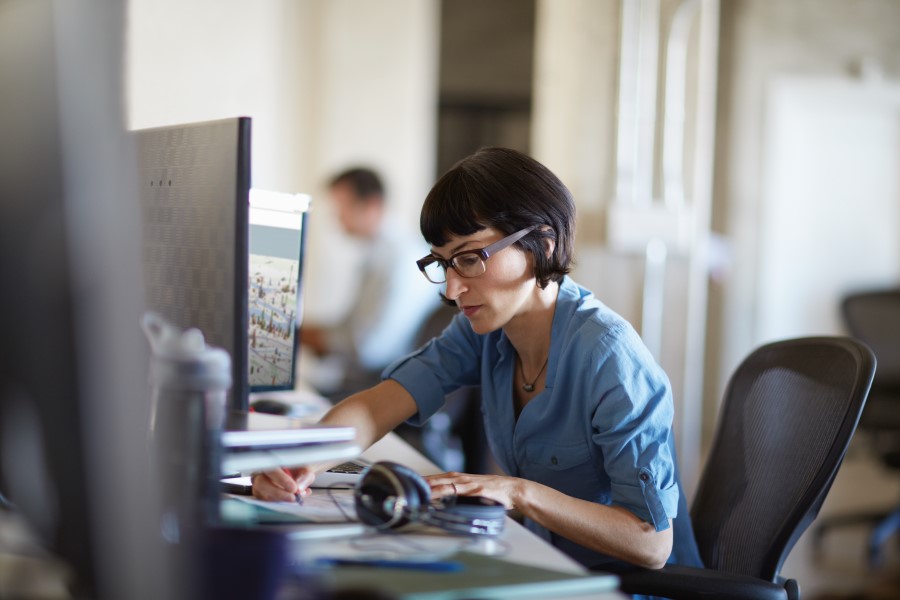 a woman sitting at a table using a laptop