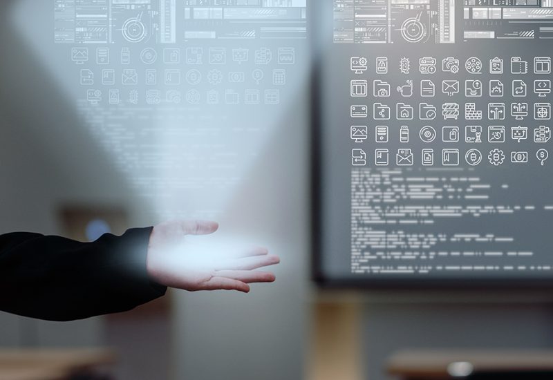 Business AI and IOT concept, Hand of businesswoman in gesture showing the various icon of smart city Internet of Things Technology on modern office