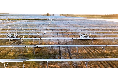 Autonomous vehicles help workers in a solar farm