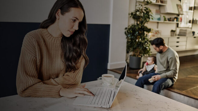 woman working from home with family in the background