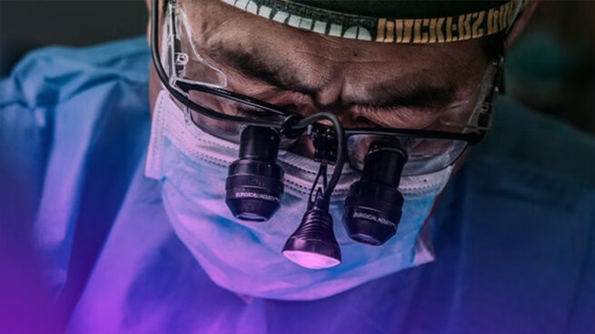 close up of a surgeon looking through special lenses