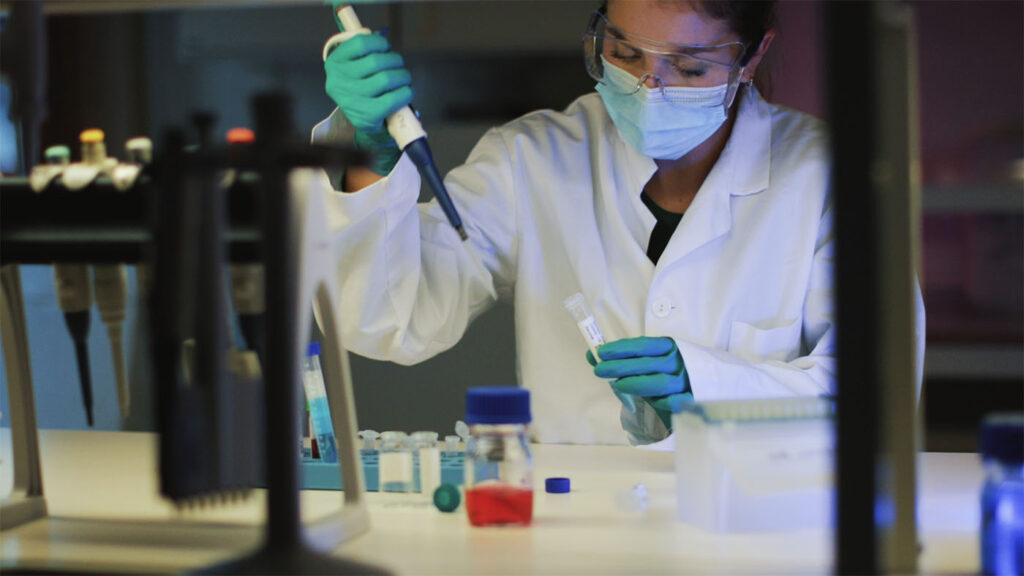Real-world evidence (RWE) - female lab technician working working with vials