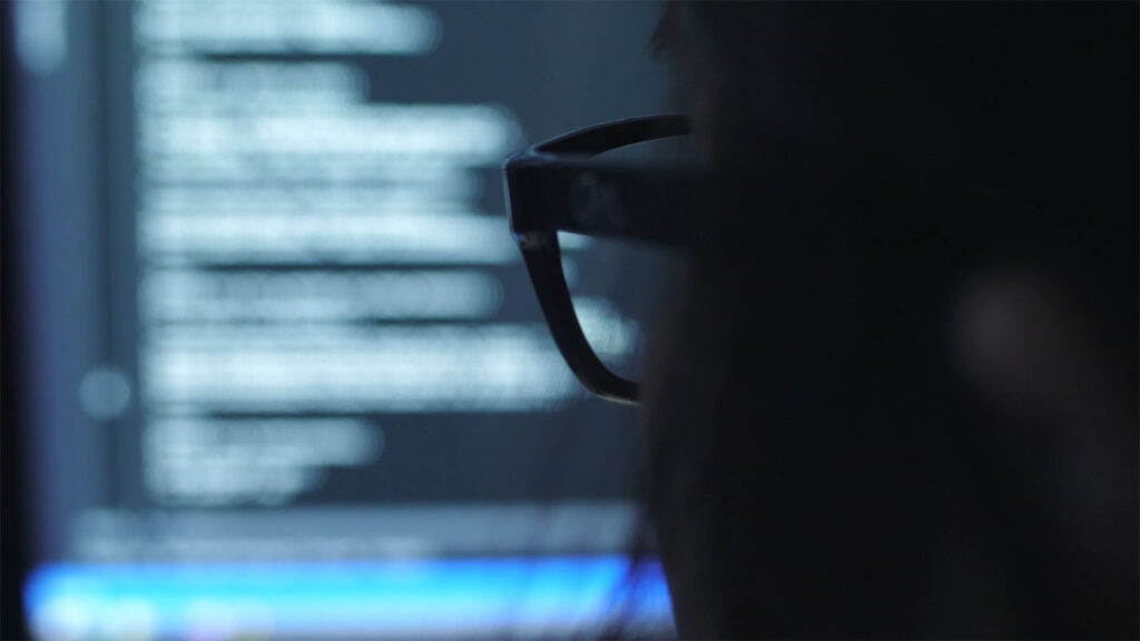 Real-world evidence (RWE) - close up of a person's glasses peering at a screen (blurred)