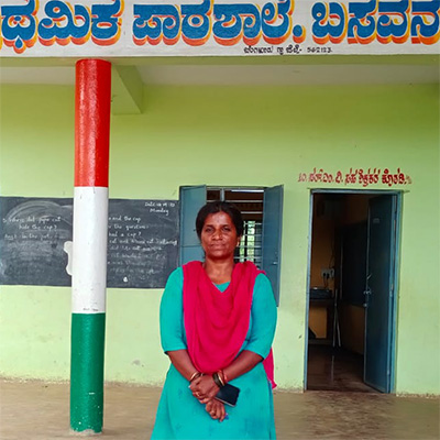 Ms. Mahalakshmi standing in front of a classroom