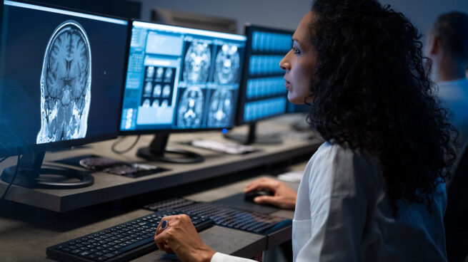 EMNLP 2023 blog hero - female radiologist analyzing an MRI image of the head