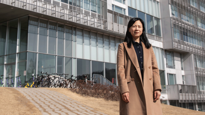 Professor Alice Oh standing in front of the Korea Advanced Institute of Science and Technology (KAIST)