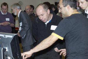 Marco Pantani et al. looking at a laptop