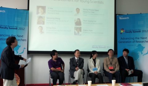 a group of people standing in front of a table