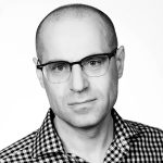 Michael Schwarz wearing glasses posing for the camera