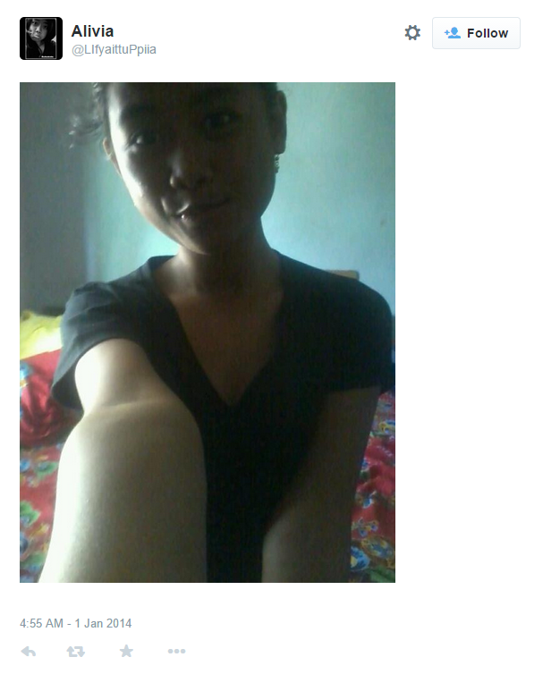 Selfie of a girl with black hair in a room with red cloth