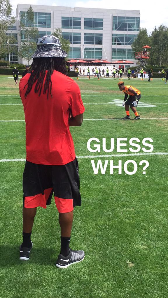 Man standing on sportsfield with the text 