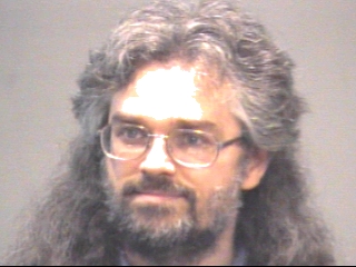 a man wearing glasses and looking at the camera