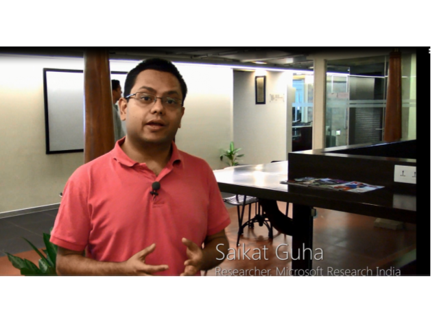 a man sitting at a table in front of a window