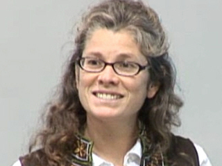 Kristin Lauter wearing glasses and smiling at the camera
