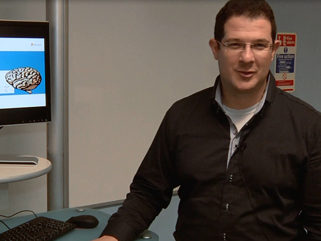 a man standing in front of a computer