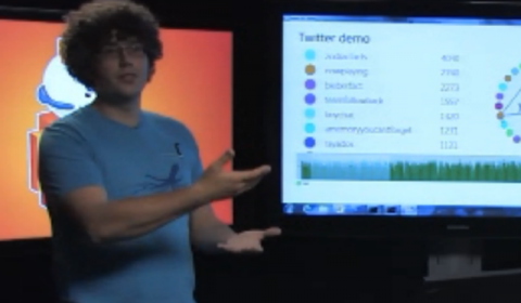 a man standing in front of a computer screen