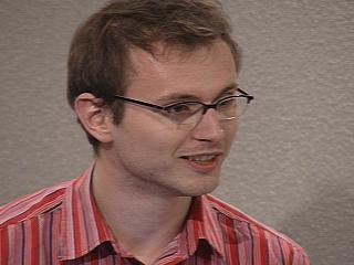 a man wearing glasses and looking at the camera