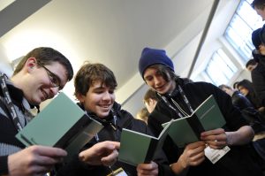 a group of people looking at a cell phone