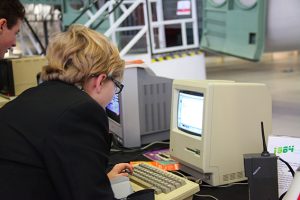 a man sitting at a desk in front of a computer
