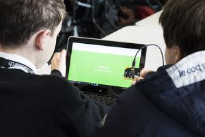 a group of people looking at a laptop