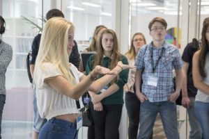 a group of people standing next to a window