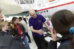 a group of people standing around a plane