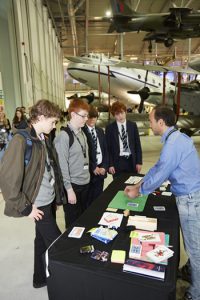 a group of people standing on top of a suitcase