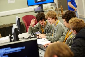 a group of people looking at a computer