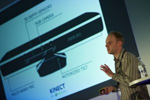 a man standing in front of a screen