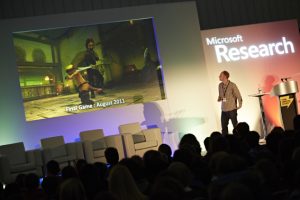 a group of people watching a band on stage in front of a crowd