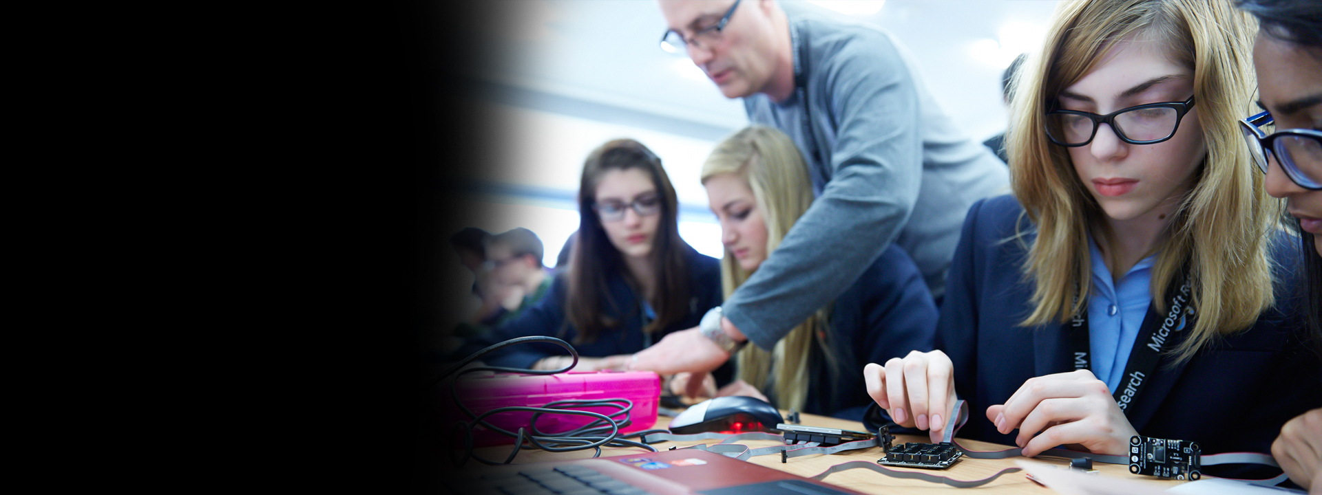 a woman sitting at a table using a laptop