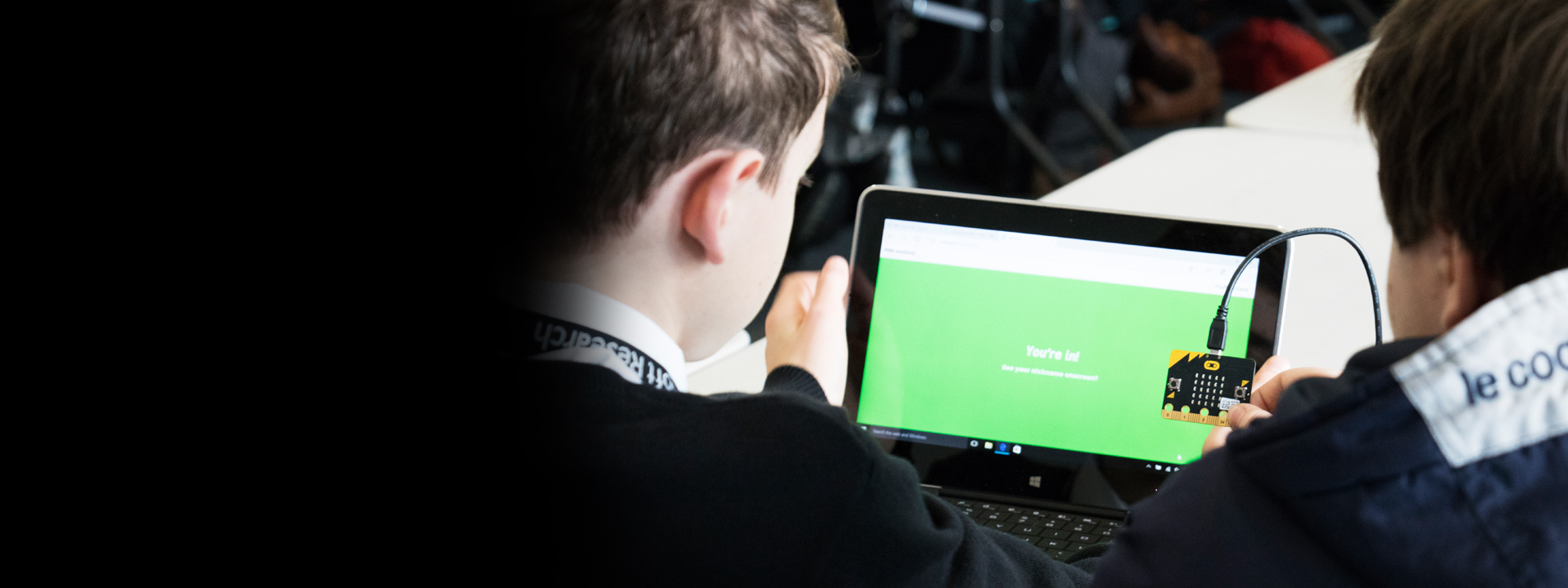 a man sitting in front of a laptop