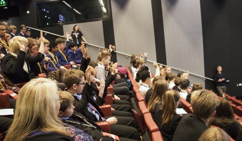 a group of people sitting in front of a crowd