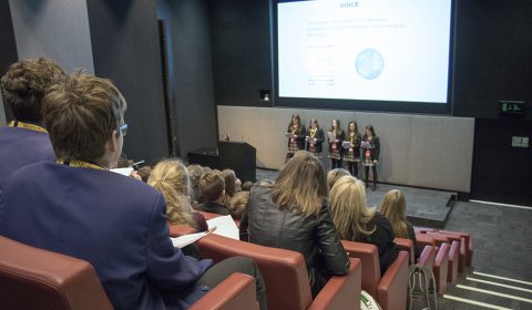 a group of people sitting in front of a television