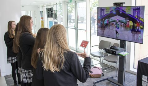 a woman standing in front of a window